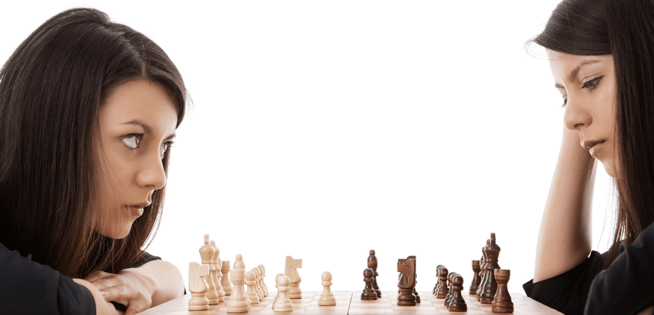 Girl playing herself at chess