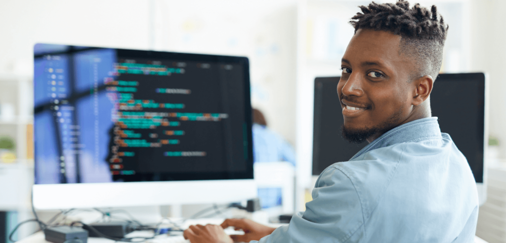 Young man learning to code at a computer