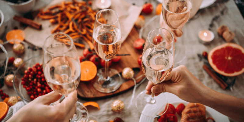 Employees clinking glasses at a festive table