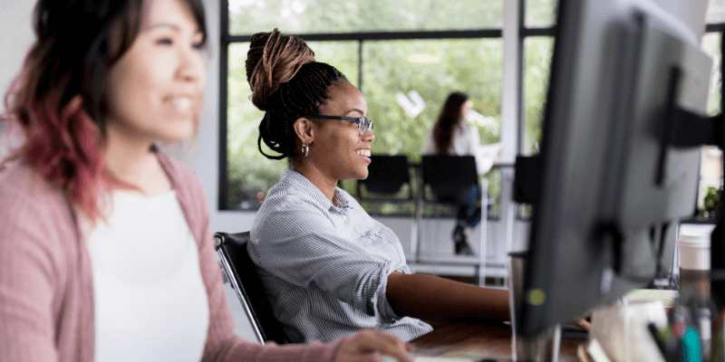 Women working at computers in a large spacious office