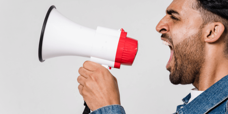 Man shouting into a loudhaler