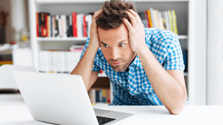 Man reads bad news on his laptop