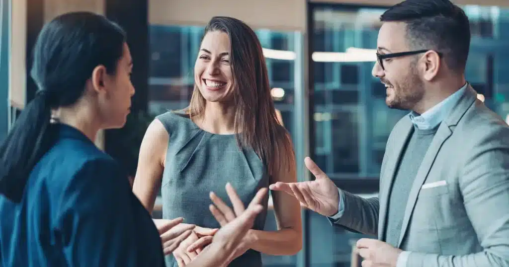 two woman and a man network, chatting about all things work related and hoping to get a referral for a role in the future