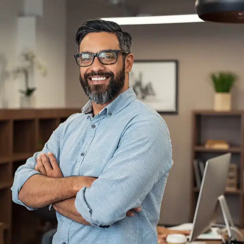 A hiring manager smiles after making a good hire with the help of Adria Solutions
