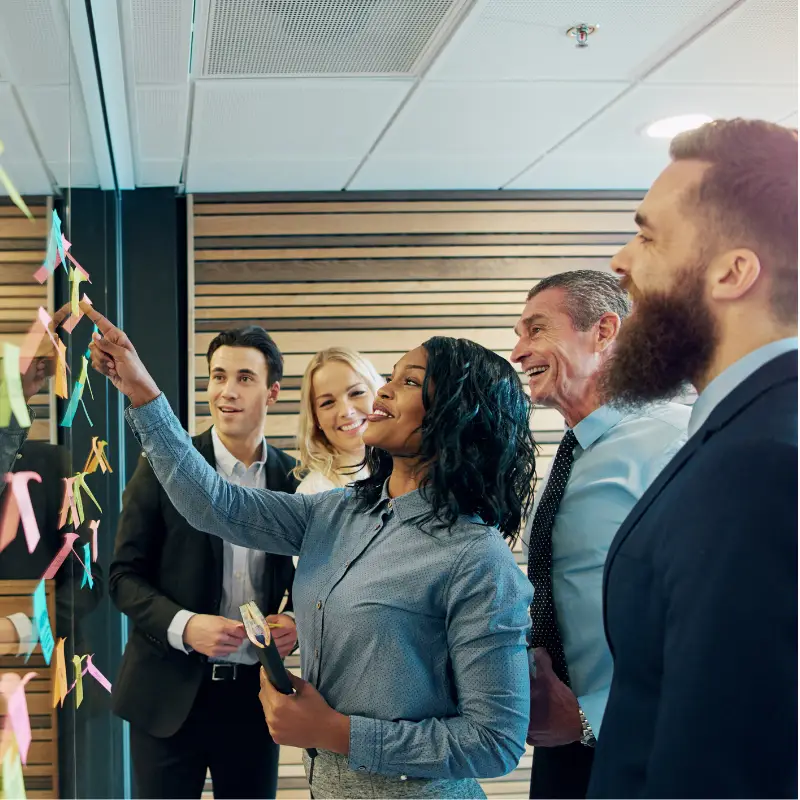 A female scrum manager discusses her tech project with her team