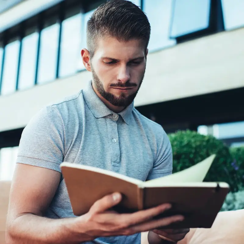 A man outside of the office looks worried that he won't do a good job interview without his interview notes