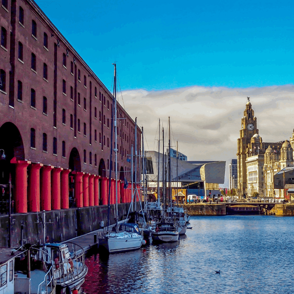 Boats moored at Liverpool’s historic Albert Dock with the Liver Building and waterfront architecture in the background.
