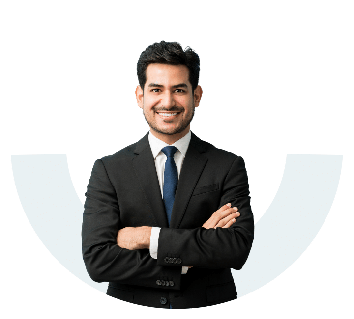 A smiling male professional in a black suit and blue tie standing confidently in front of a light blue semi-circle graphic.
