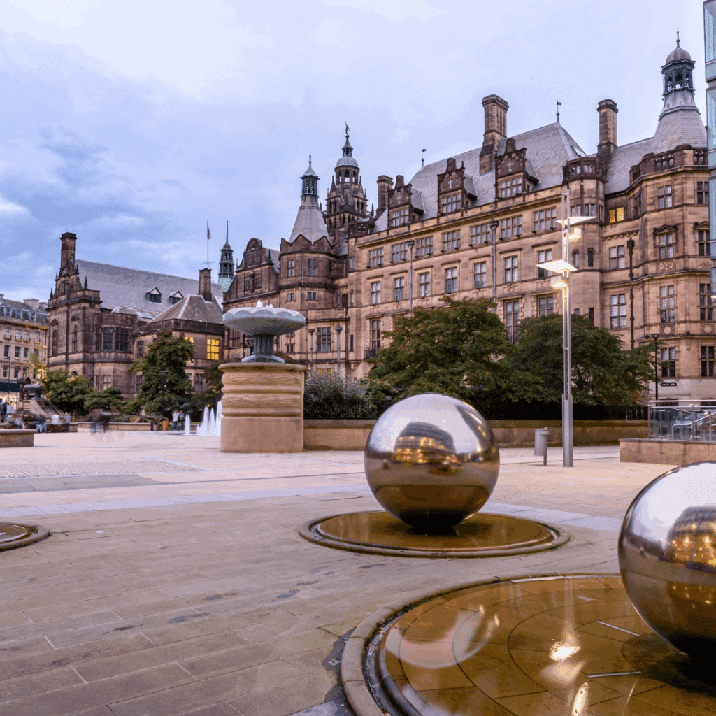 The Peace Gardens in Sheffield city centre featuring ornamental fountains and polished steel spheres.