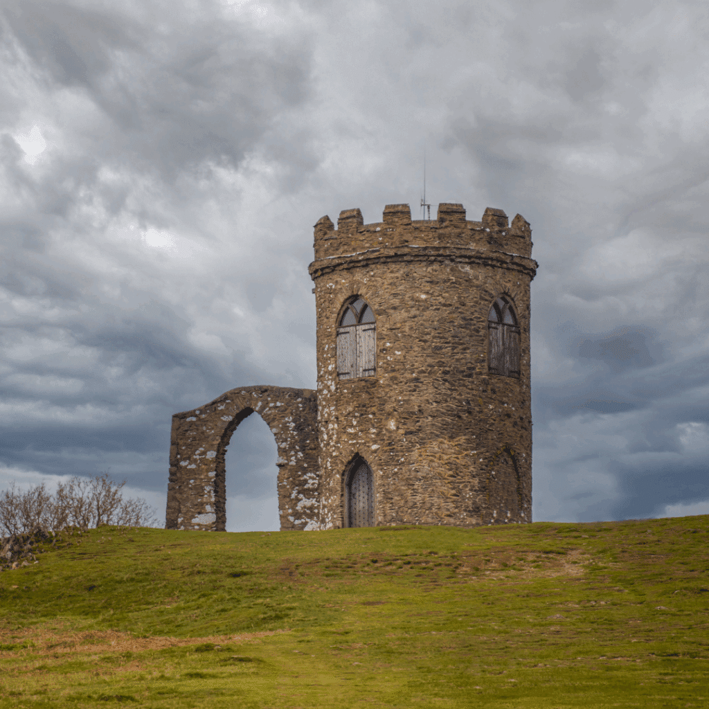 The iconic Old John Tower on a hilltop in Bradgate Park near Leicester beneath a moody sky.