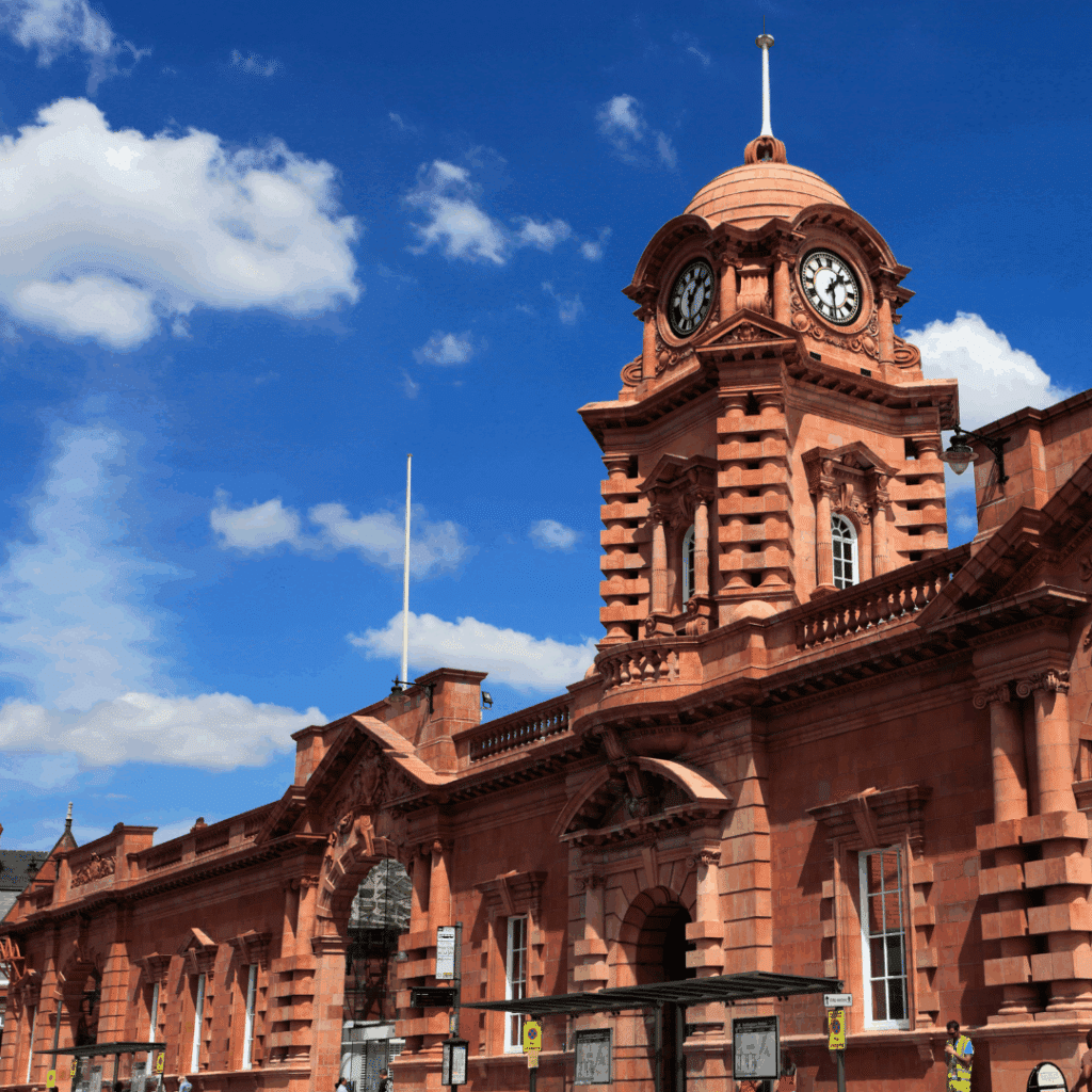 The red-brick clock tower of the former Victoria Station in Nottingham under a blue sky, a landmark of the city’s transport history.