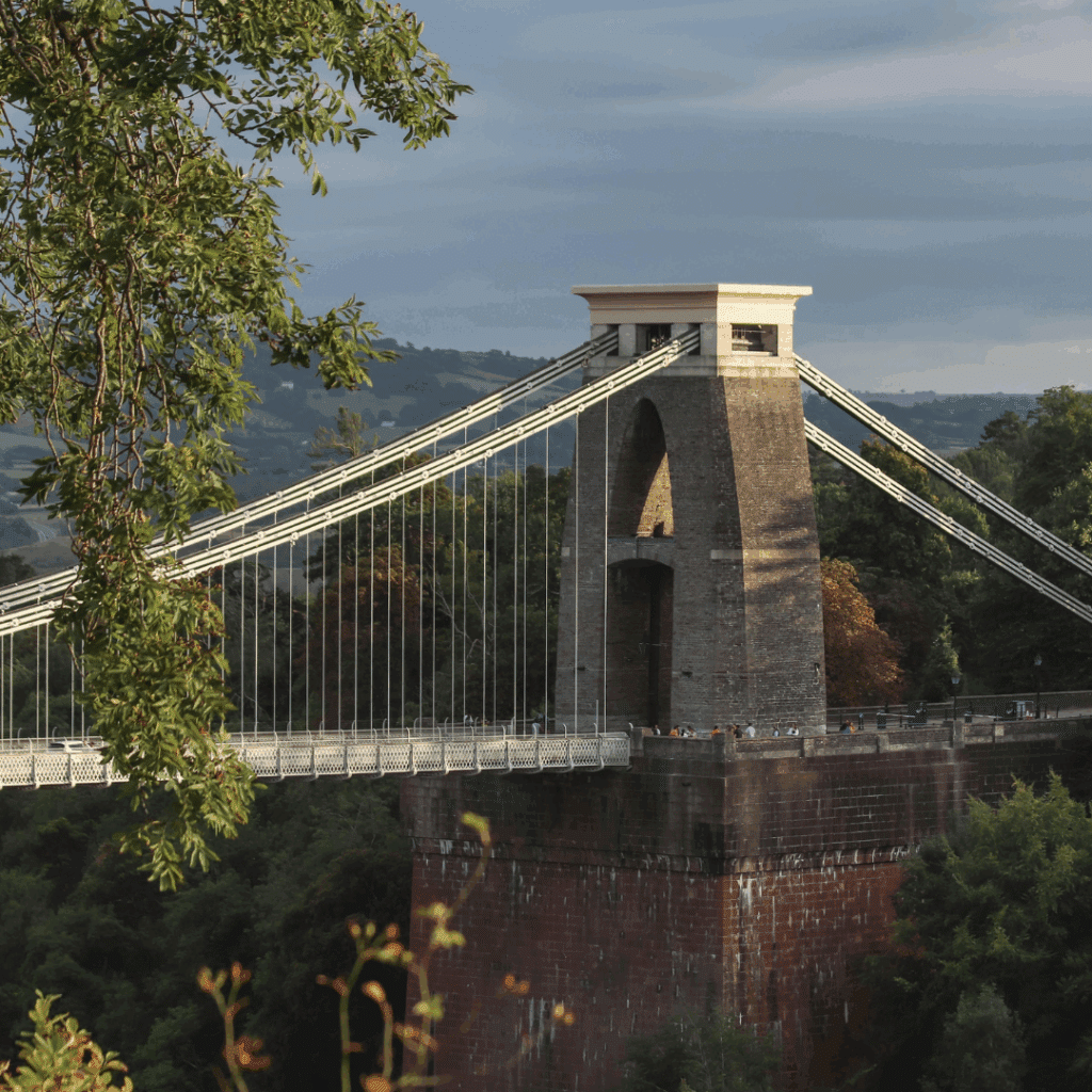 Close-up of one of the towers of Clifton Suspension Bridge surrounded by trees.