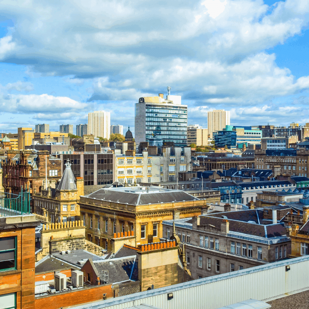 A view of Glasgow's mixed modern and historic architecture under a partly cloudy sky.