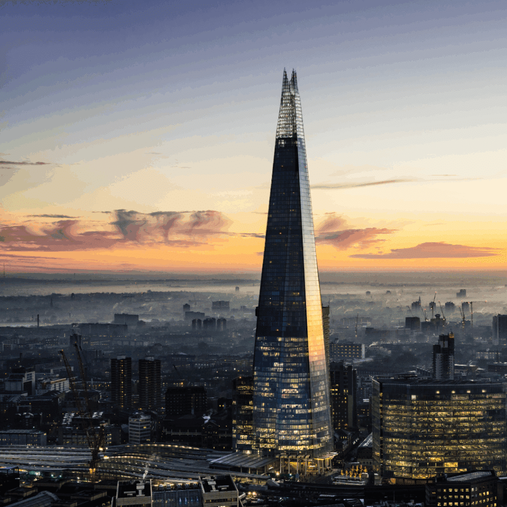 The Shard rising above the London skyline at dusk with a colourful sky and cityscape in the background