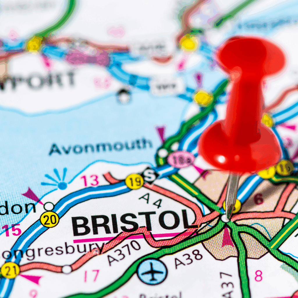 Close-up of a road map with a red pushpin marking the city of Bristol.