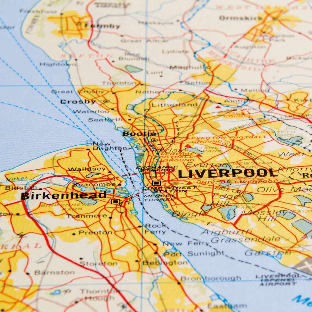 Close-up of a printed map highlighting the city of Liverpool and nearby locations like Birkenhead, Bootle, and Crosby.