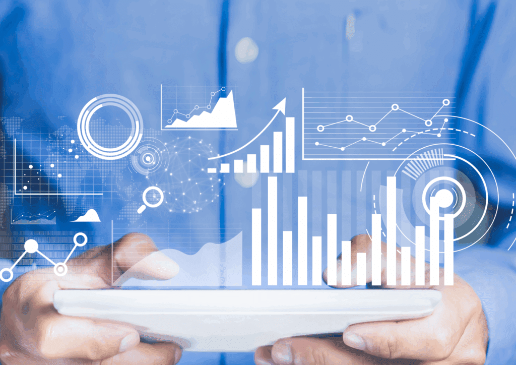 Hands holding a tablet with various digital data visualisations and graphs overlaid, representing data analytics in a technology-driven environment.