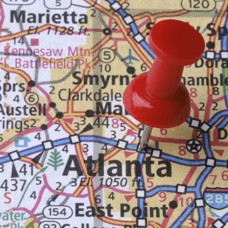 Close-up of a map showing Atlanta, Georgia with a red pushpin marking the city, highlighting nearby areas such as Marietta and Smyrna.