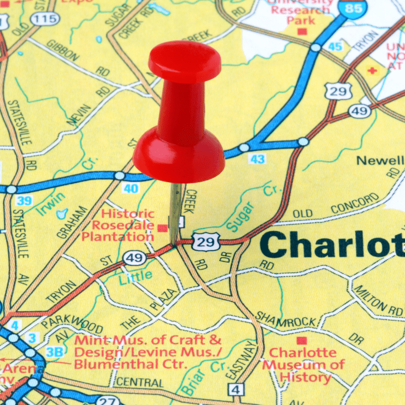 Close-up of a map showing Charlotte, North Carolina, with a red pushpin marking the city and nearby landmarks including Historic Rosedale Plantation and University Research Park.