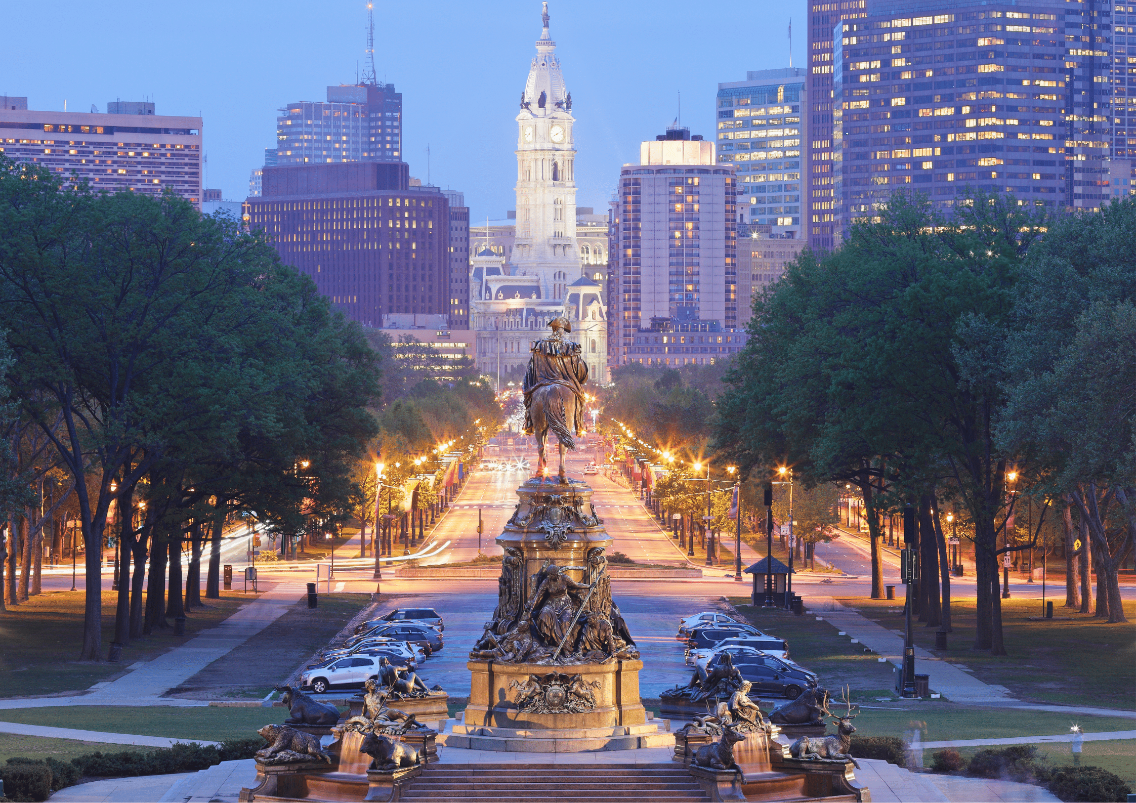 View of Philadelphia’s skyline with City Hall and Benjamin Franklin Parkway at dusk.