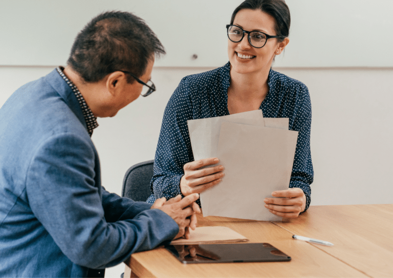 Recruitment consultant reviewing CV documents with a candidate