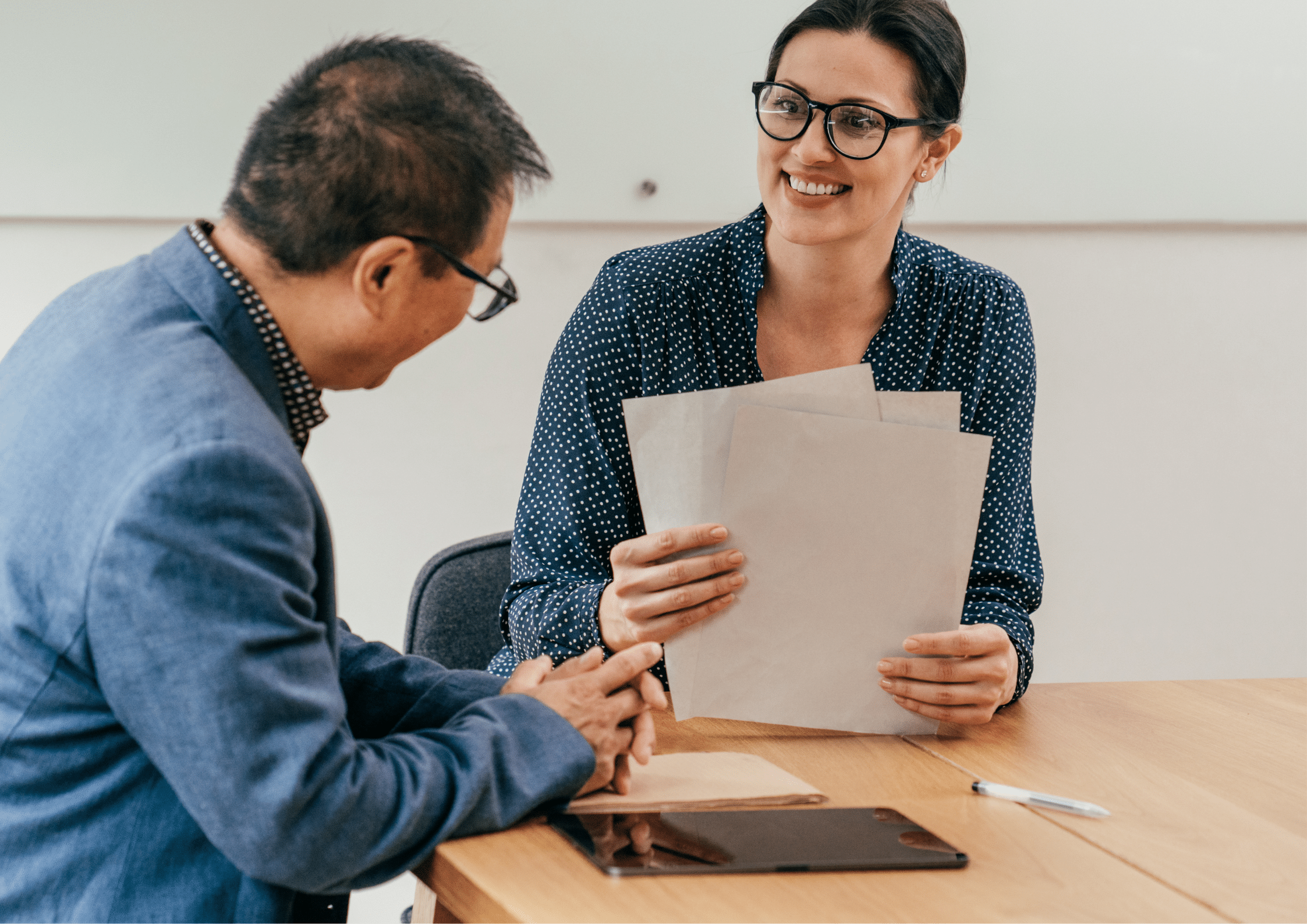 Recruitment consultant reviewing CV documents with a candidate
