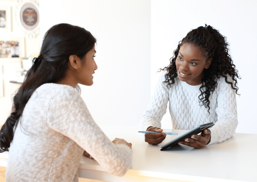 Recruitment advisor speaking with a candidate at a desk